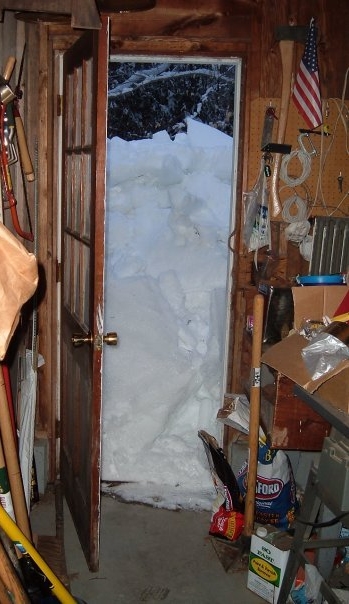 Snow is piled up in front of our back door in Maine.