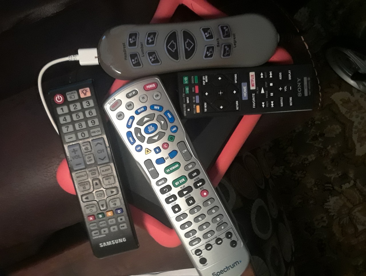 A collection of remote controls and electronic devices represents our dependence upon technology.