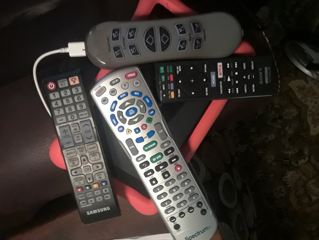 A collection of remote controls and electronic devices represents our dependence upon technology.